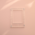DIY Decoden customizable clear Polaroid loader frames with frosting-inspired glue, decorative sprinkles, charms, and magnets for personalizing your photos.