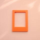 DIY Decoden customizable orange   Polaroid loader frames with frosting-inspired glue, decorative sprinkles, charms, and magnets for personalizing your photos.