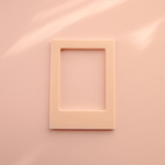DIY Decoden customizable soft pink Polaroid loader frames with frosting-inspired glue, decorative sprinkles, charms, and magnets for personalizing your photos.