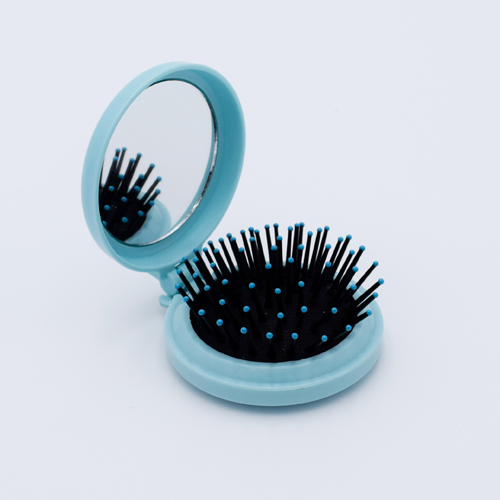 DIY Decoden customizable compact brush with mirror, adorned with charms and frosting-inspired glue, in pastel blue for easy touch-ups.