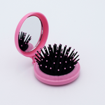 DIY Decoden customizable compact brush with mirror, adorned with charms and frosting-inspired glue, in deco pink for easy touch-ups.