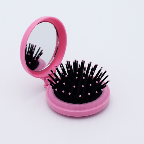 DIY Decoden customizable compact brush with mirror, adorned with charms and frosting-inspired glue, in deco pink for easy touch-ups.