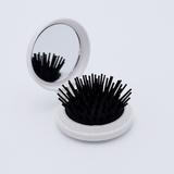 DIY Decoden customizable compact brush with mirror, adorned with charms and frosting-inspired glue, in white for easy touch-ups.