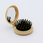 DIY Decoden customizable compact brush with mirror, adorned with charms and frosting-inspired glue, in soft yellow for easy touch-ups.