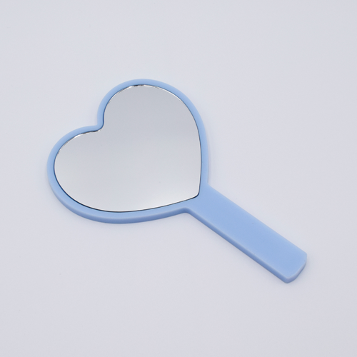 DIY Decoden customizable hand-held heart mirror in pastel blue with frosting-inspired glues, sprinkles, and charms, perfect for adding a personal touch to your routine.