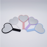 DIY Decoden customizable hand-held heart mirror with frosting-inspired glues, sprinkles, and charms, perfect for adding a personal touch to your routine.