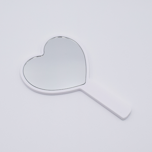 DIY Decoden customizable hand-held heart mirror in white with frosting-inspired glues, sprinkles, and charms, perfect for adding a personal touch to your routine.