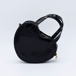 DIY Decoden customizable heart-shaped purse in black with frosting-inspired glues, decorative sprinkles, and charms, featuring a detachable gold cross-body chain.