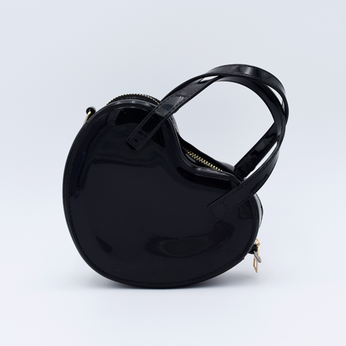 DIY Decoden customizable heart-shaped purse in black with frosting-inspired glues, decorative sprinkles, and charms, featuring a detachable gold cross-body chain.