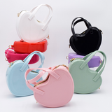 DIY Decoden customizable heart-shaped purse with frosting-inspired glues, decorative sprinkles, and charms, featuring a detachable gold cross-body chain, and available in an assortment of cute colors.