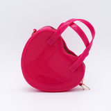 DIY Decoden customizable heart-shaped purse in rose pink with frosting-inspired glues, decorative sprinkles, and charms, featuring a detachable gold cross-body chain.