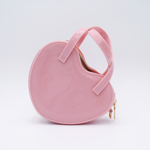 DIY Decoden customizable heart-shaped purse in deco pink with frosting-inspired glues, decorative sprinkles, and charms, featuring a detachable gold cross-body chain.