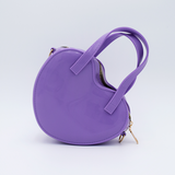 DIY Decoden customizable heart-shaped purse in pastel purple with frosting-inspired glues, decorative sprinkles, and charms, featuring a detachable gold cross-body chain.