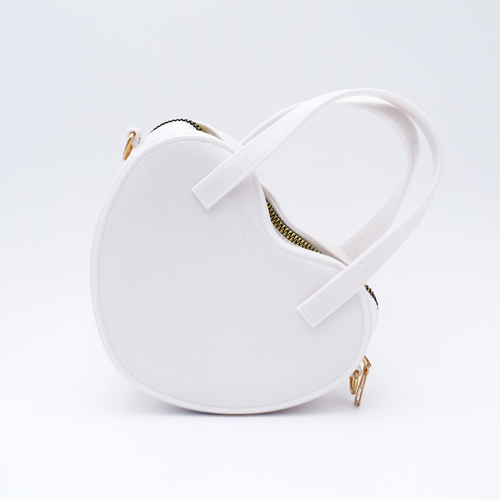 DIY Decoden customizable heart-shaped purse in white with frosting-inspired glues, decorative sprinkles, and charms, featuring a detachable gold cross-body chain.