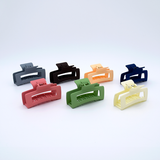 DIY Decoden customizable large hair claw in various colors, with frosting-inspired glue, decorative sprinkles, and charms, ready for decoration.