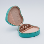 DIY Decoden customizable travel heart-shaped jewelry box in turquoise with frosting-inspired glues, decorative sprinkles, and charms. Perfect for keeping jewelry safe and stylish on the go.