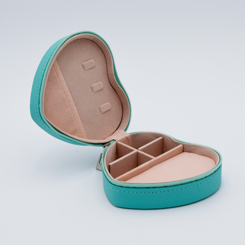 DIY Decoden customizable travel heart-shaped jewelry box in turquoise with frosting-inspired glues, decorative sprinkles, and charms. Perfect for keeping jewelry safe and stylish on the go.