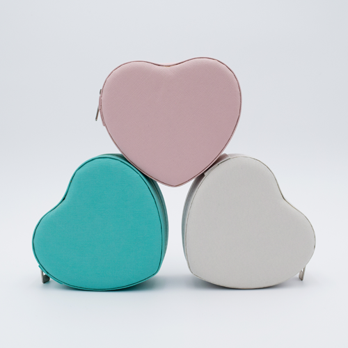 DIY Decoden customizable travel heart-shaped jewelry box with frosting-inspired glues, decorative sprinkles, and charms. Perfect for keeping jewelry safe and stylish on the go.