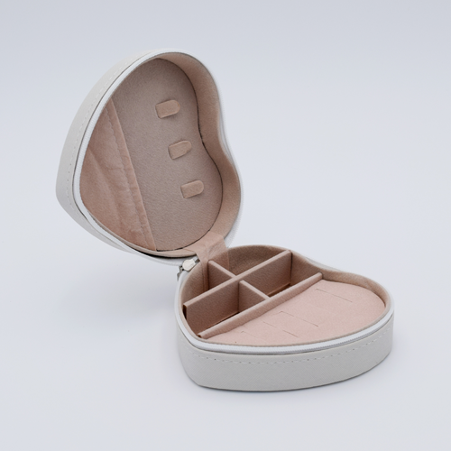 DIY Decoden customizable travel heart-shaped jewelry box in white with frosting-inspired glues, decorative sprinkles, and charms. Perfect for keeping jewelry safe and stylish on the go.