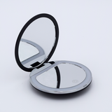 DIY Decoden customizable compact LED mirror in black with frosting-inspired glues, decorative sprinkles, and charms for personalization. Includes built-in LED light and charging cable.