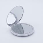 DIY Decoden customizable compact LED mirror in white with frosting-inspired glues, decorative sprinkles, and charms for personalization. Includes built-in LED light and charging cable.