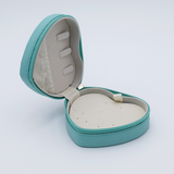 DIY Decoden customizable travel heart-shaped jewelry box in light blue with frosting-inspired glues, decorative sprinkles, and charms. Perfect for keeping jewelry safe and stylish on the go.