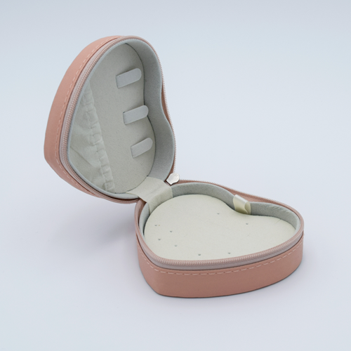 DIY Decoden customizable travel heart-shaped jewelry box in blush pink with frosting-inspired glues, decorative sprinkles, and charms. Perfect for keeping jewelry safe and stylish on the go.