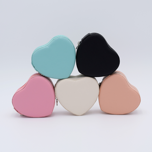 DIY Decoden customizable travel heart-shaped jewelry box with frosting-inspired glues, decorative sprinkles, and charms. Perfect for keeping jewelry safe and stylish on the go.