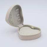 DIY Decoden customizable travel heart-shaped jewelry box in white with frosting-inspired glues, decorative sprinkles, and charms. Perfect for keeping jewelry safe and stylish on the go.