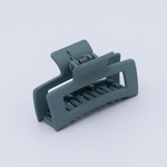 DIY Decoden customizable mini hair claw in sea foam green, with frosting-inspired glue, decorative sprinkles, and charms, ready for decoration.