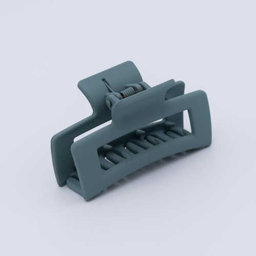 DIY Decoden customizable mini hair claw in sea foam green, with frosting-inspired glue, decorative sprinkles, and charms, ready for decoration.