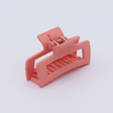 DIY Decoden customizable mini hair claw in peach, with frosting-inspired glue, decorative sprinkles, and charms, ready for decoration.