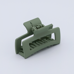 DIY Decoden customizable mini hair claw in soft green, with frosting-inspired glue, decorative sprinkles, and charms, ready for decoration.