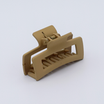 DIY Decoden customizable mini hair claw in coffee, with frosting-inspired glue, decorative sprinkles, and charms, ready for decoration.