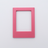 DIY Decoden customizable candy pink Polaroid loader frames with frosting-inspired glue, decorative sprinkles, charms, and magnets for personalizing your photos.