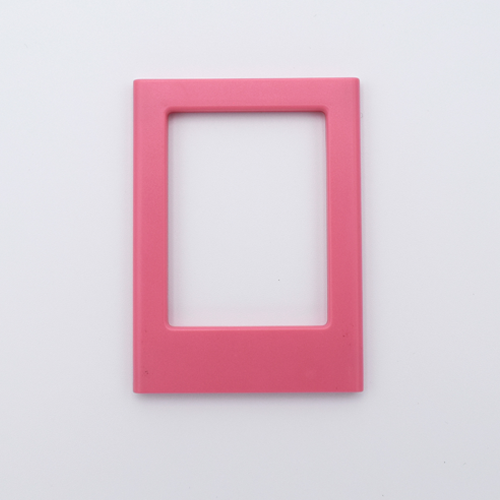 DIY Decoden customizable candy pink Polaroid loader frames with frosting-inspired glue, decorative sprinkles, charms, and magnets for personalizing your photos.