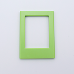 DIY Decoden customizable lime green Polaroid loader frames with frosting-inspired glue, decorative sprinkles, charms, and magnets for personalizing your photos.