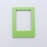 DIY Decoden customizable lime green Polaroid loader frames with frosting-inspired glue, decorative sprinkles, charms, and magnets for personalizing your photos.