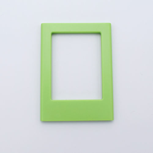 DIY Decoden customizable lime green Polaroid loader frames with frosting-inspired glue, decorative sprinkles, charms, and magnets for personalizing your photos.