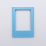 DIY Decoden customizable sky blue Polaroid loader frames with frosting-inspired glue, decorative sprinkles, charms, and magnets for personalizing your photos.