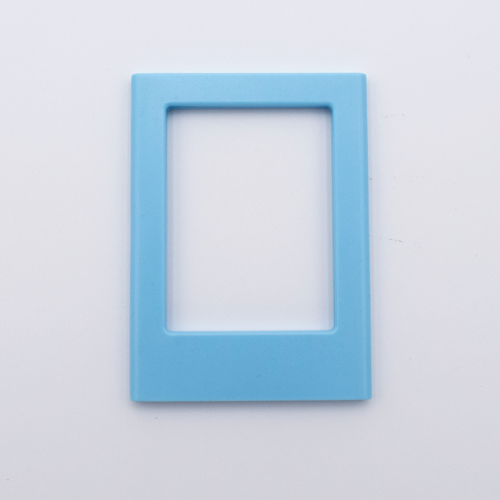 DIY Decoden customizable sky blue Polaroid loader frames with frosting-inspired glue, decorative sprinkles, charms, and magnets for personalizing your photos.