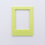 DIY Decoden customizable soft yellow Polaroid loader frames with frosting-inspired glue, decorative sprinkles, charms, and magnets for personalizing your photos.