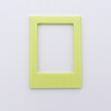 DIY Decoden customizable soft yellow Polaroid loader frames with frosting-inspired glue, decorative sprinkles, charms, and magnets for personalizing your photos.