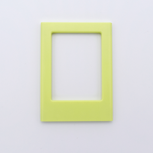 DIY Decoden customizable soft yellow Polaroid loader frames with frosting-inspired glue, decorative sprinkles, charms, and magnets for personalizing your photos.