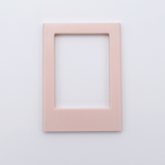 DIY Decoden customizable soft pink Polaroid loader frames with frosting-inspired glue, decorative sprinkles, charms, and magnets for personalizing your photos.