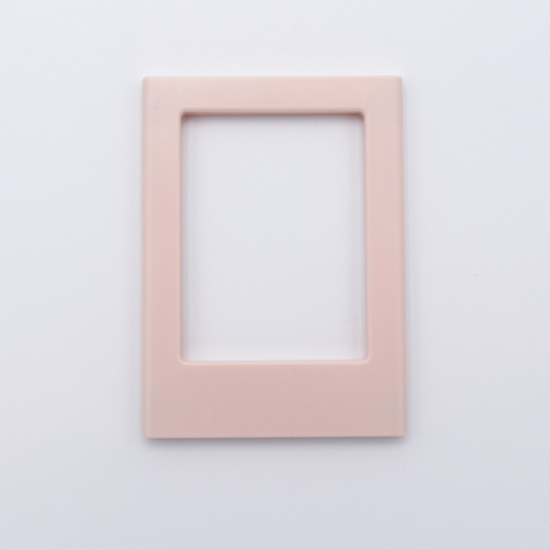 DIY Decoden customizable soft pink Polaroid loader frames with frosting-inspired glue, decorative sprinkles, charms, and magnets for personalizing your photos.