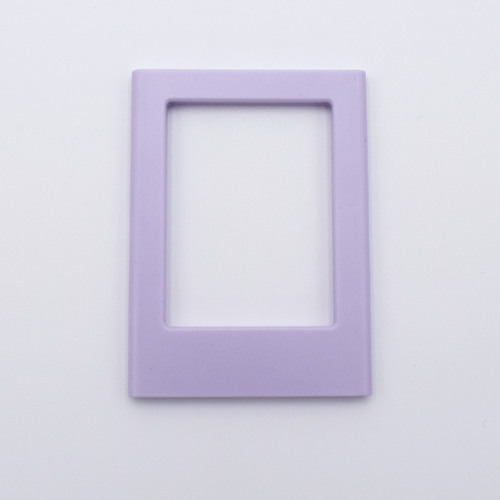 DIY Decoden customizable lilac Polaroid loader frames with frosting-inspired glue, decorative sprinkles, charms, and magnets for personalizing your photos.