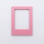 DIY Decoden customizable blush pink Polaroid loader frames with frosting-inspired glue, decorative sprinkles, charms, and magnets for personalizing your photos.