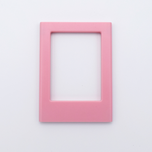 DIY Decoden customizable blush pink Polaroid loader frames with frosting-inspired glue, decorative sprinkles, charms, and magnets for personalizing your photos.