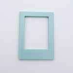 DIY Decoden customizable sea foam green Polaroid loader frames with frosting-inspired glue, decorative sprinkles, charms, and magnets for personalizing your photos.